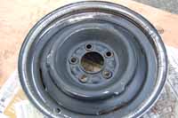 Photo shows how the wheel should look after sanding off the rust and loose paint, before priming and spray painting